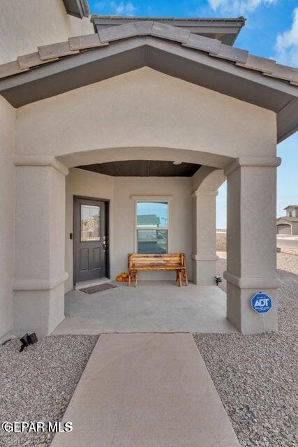 property entrance with stucco siding