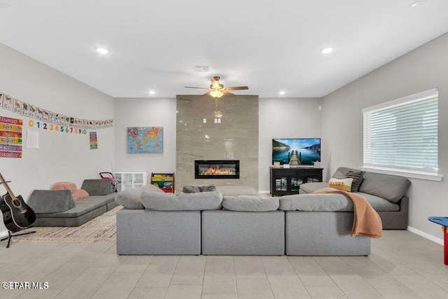 living room with visible vents, a ceiling fan, recessed lighting, baseboards, and a tile fireplace