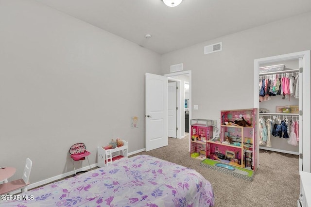 bedroom with a walk in closet, carpet flooring, visible vents, and a closet