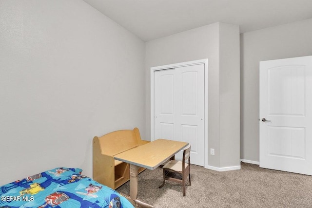 carpeted bedroom featuring baseboards