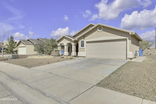 single story home featuring stucco siding, an attached garage, and driveway