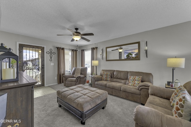 living room with a textured ceiling and a ceiling fan