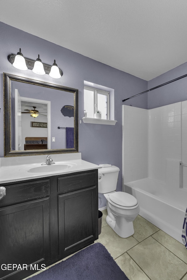 bathroom featuring vanity, ceiling fan, tile patterned flooring, a textured ceiling, and toilet