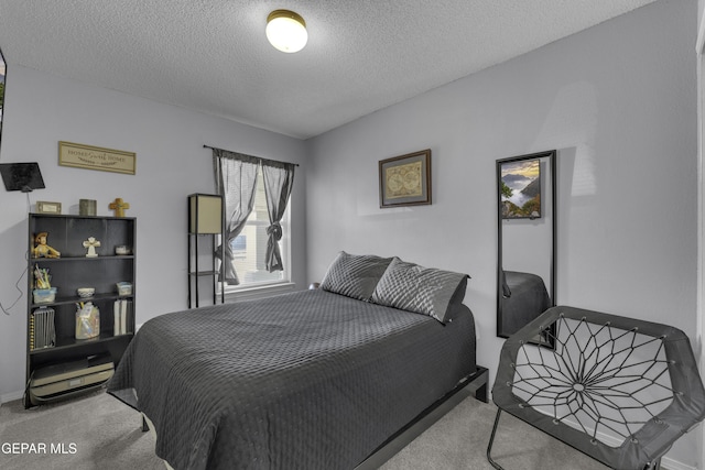 bedroom featuring carpet and a textured ceiling