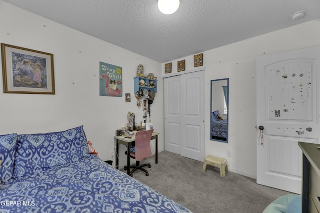 bedroom with a closet, a textured ceiling, and carpet