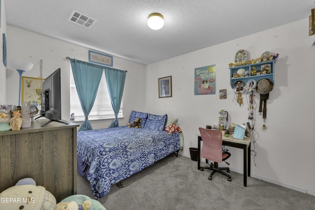 carpeted bedroom with visible vents, baseboards, and a textured ceiling