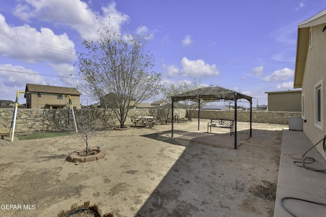 view of yard with a gazebo, a fenced backyard, and a patio area