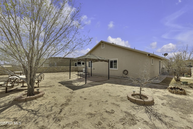 back of property with a patio