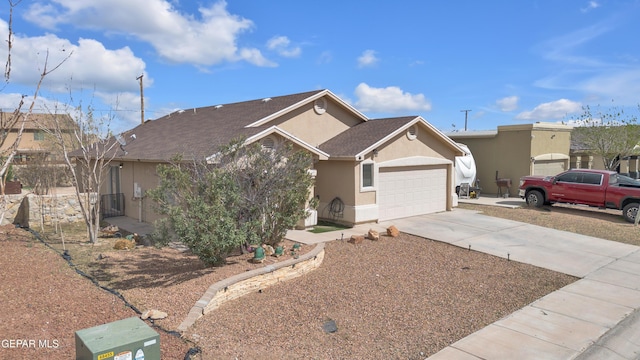 ranch-style home with stucco siding, an attached garage, and concrete driveway