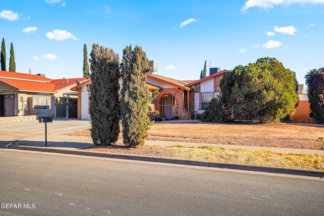 obstructed view of property with a garage and driveway