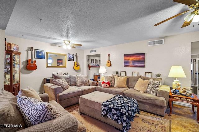 living room with visible vents, a textured ceiling, and a ceiling fan