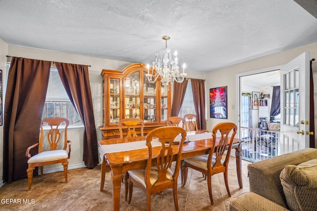 dining room featuring a notable chandelier and a textured ceiling