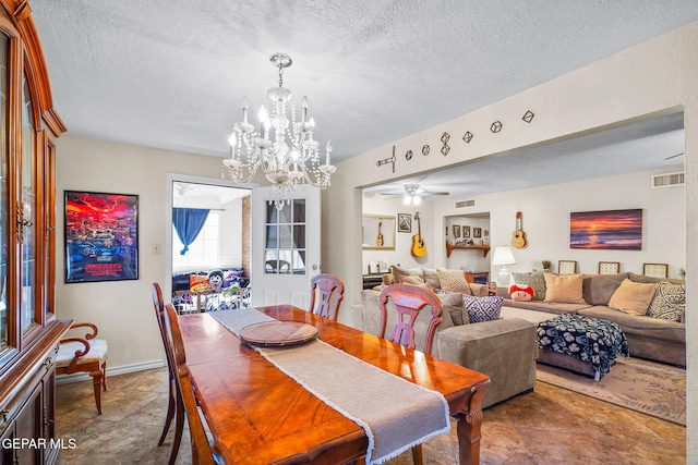 dining area with visible vents, ceiling fan with notable chandelier, and a textured ceiling