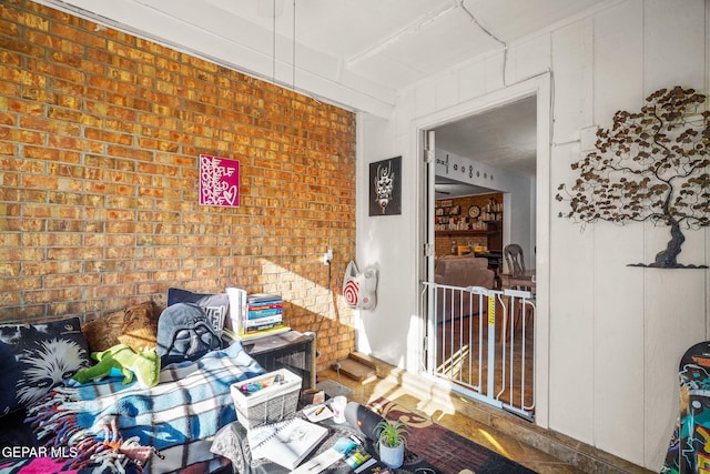 interior space featuring brick wall