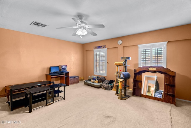 interior space with carpet flooring, baseboards, visible vents, and ceiling fan