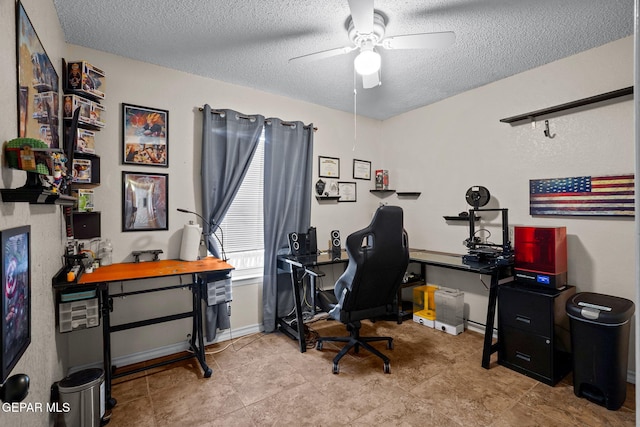 office space with baseboards, a textured ceiling, and ceiling fan