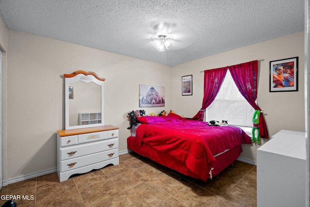 bedroom featuring a textured ceiling and baseboards