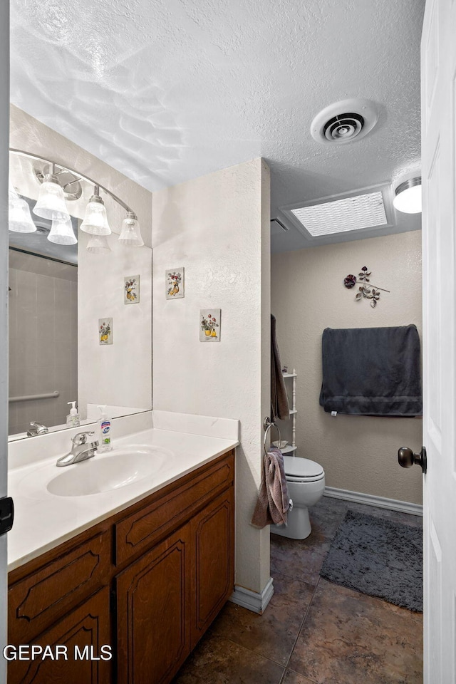 bathroom featuring visible vents, toilet, a textured ceiling, baseboards, and vanity