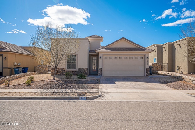 view of front facade featuring a tiled roof, stucco siding, driveway, stone siding, and an attached garage