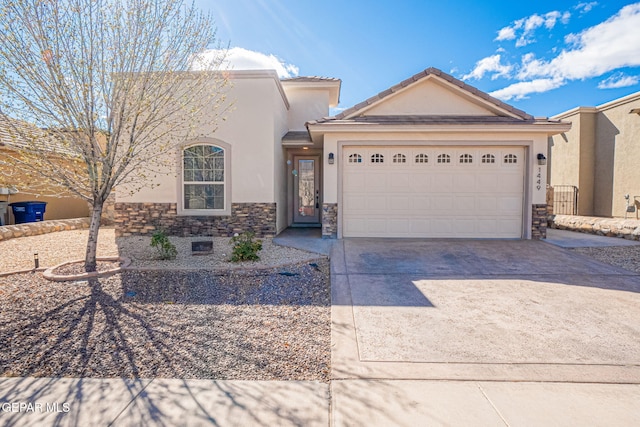 view of front facade with a tiled roof, stucco siding, driveway, stone siding, and an attached garage