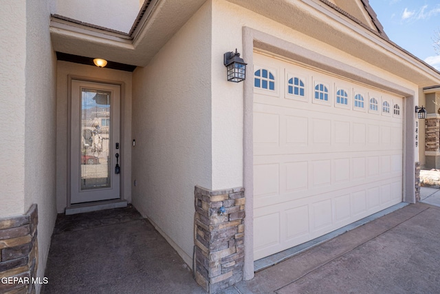 view of exterior entry with stone siding and stucco siding