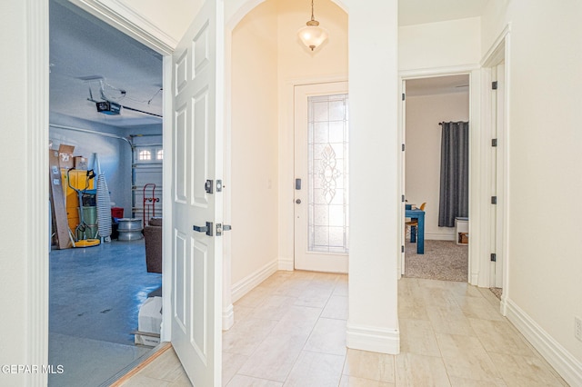 entrance foyer featuring baseboards and arched walkways