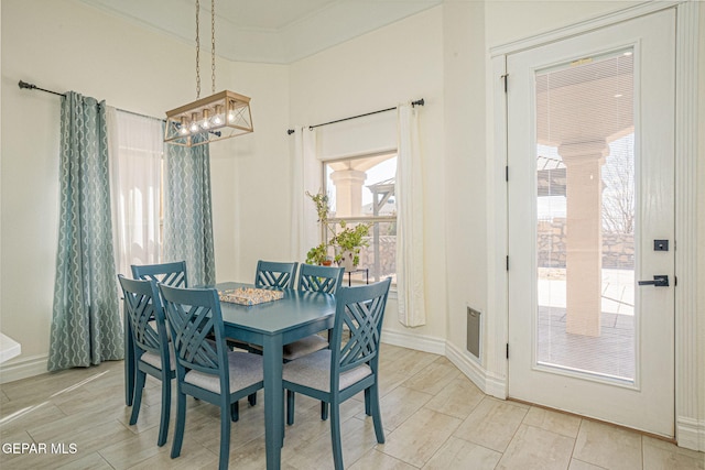 dining room featuring wood tiled floor, baseboards, and a chandelier