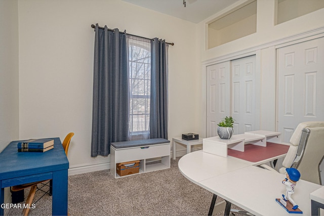 carpeted office space with baseboards