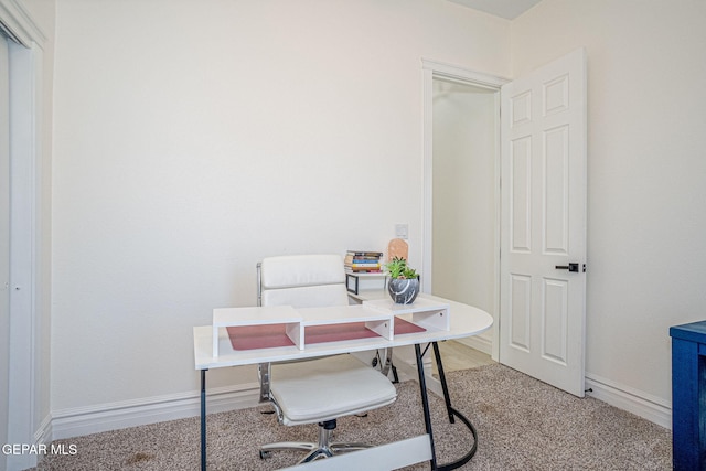 carpeted home office featuring baseboards