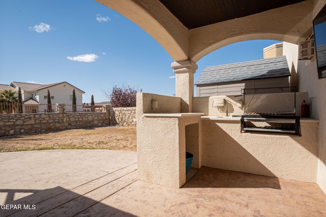 view of patio / terrace with exterior kitchen and a fenced backyard