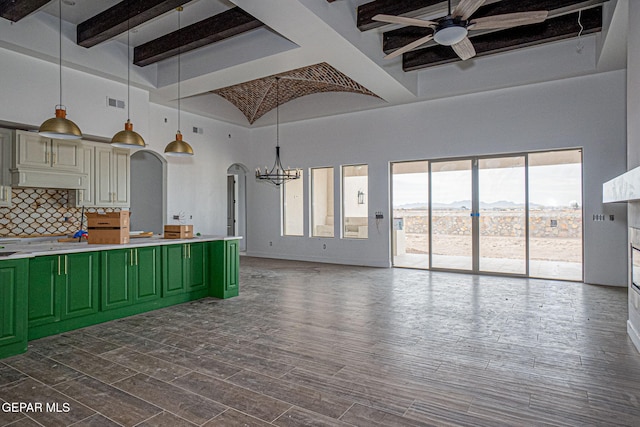 kitchen featuring baseboards, dark wood finished floors, ceiling fan with notable chandelier, a mountain view, and green cabinetry