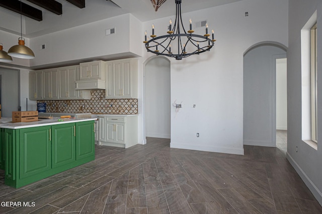 kitchen with wood finish floors, visible vents, backsplash, arched walkways, and green cabinetry