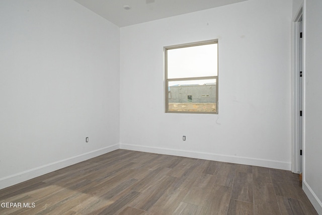 unfurnished room with wood finished floors and baseboards