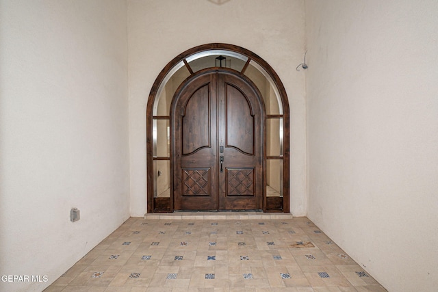 doorway to property featuring stucco siding