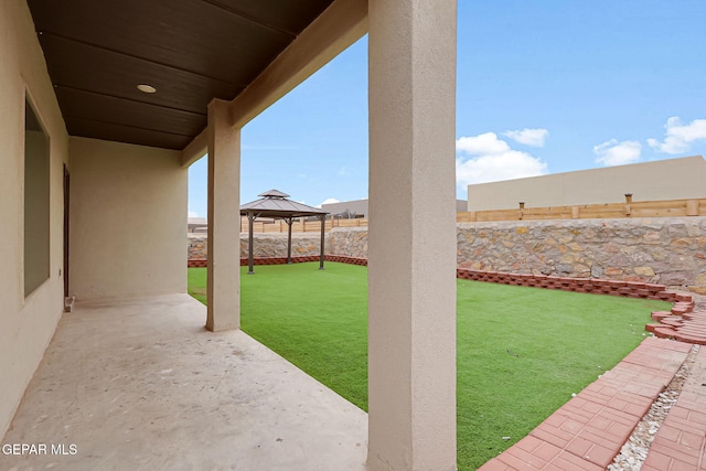 view of yard with a gazebo, a fenced backyard, and a patio