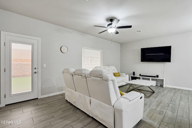 living area with baseboards, a ceiling fan, visible vents, and wood tiled floor