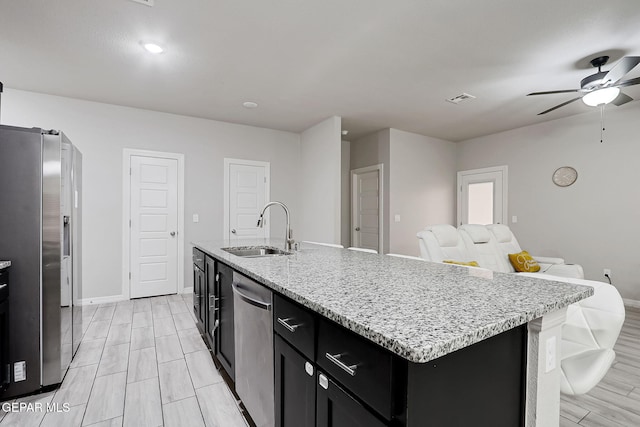 kitchen featuring visible vents, ceiling fan, a sink, appliances with stainless steel finishes, and dark cabinets