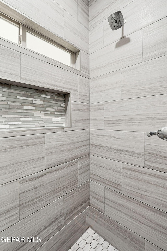 bathroom with tiled shower