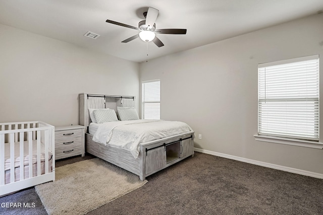 bedroom with visible vents, baseboards, a ceiling fan, and dark carpet