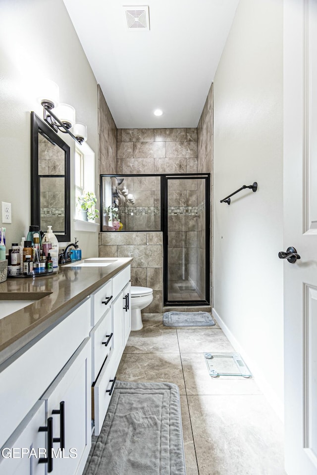 bathroom featuring visible vents, toilet, a stall shower, and vanity