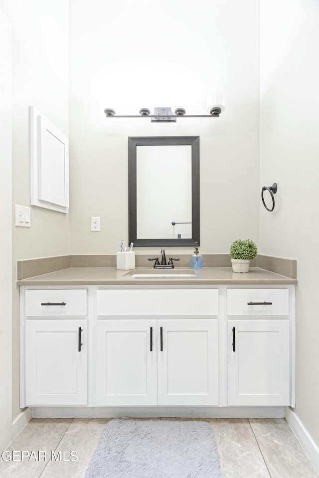 bathroom featuring baseboards and vanity