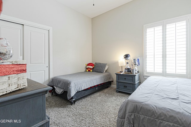 bedroom with carpet and a closet