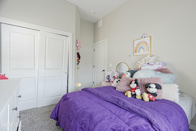 carpeted bedroom with visible vents and a closet