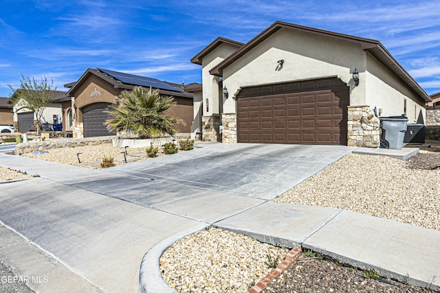 single story home featuring stone siding, stucco siding, an attached garage, and driveway