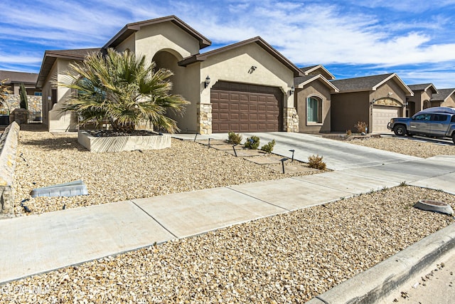 view of front of house with stone siding, a garage, driveway, and stucco siding