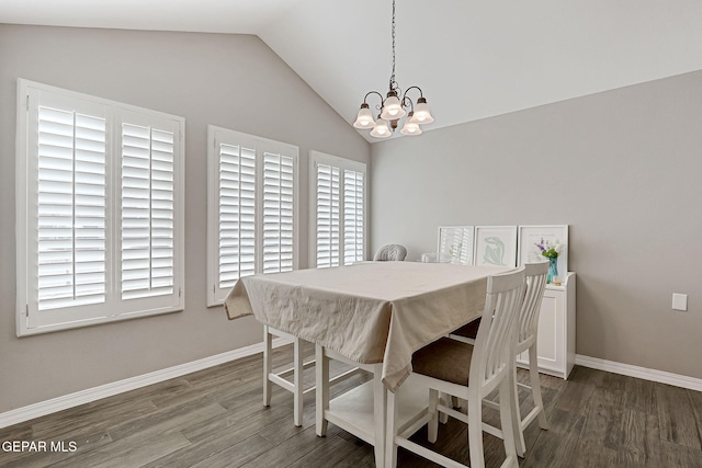 dining area with a chandelier, baseboards, lofted ceiling, and wood finished floors