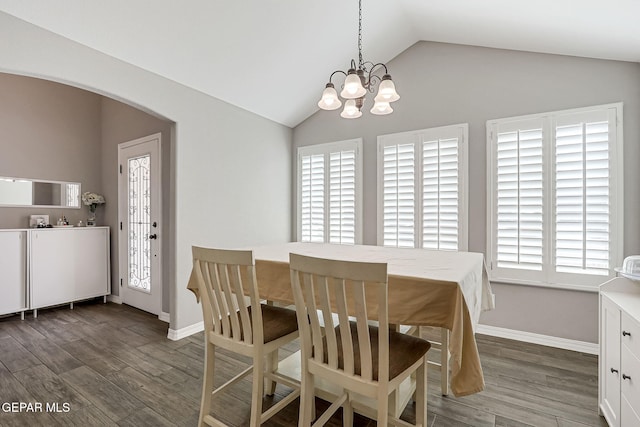 dining room featuring an inviting chandelier, lofted ceiling, wood finished floors, and arched walkways