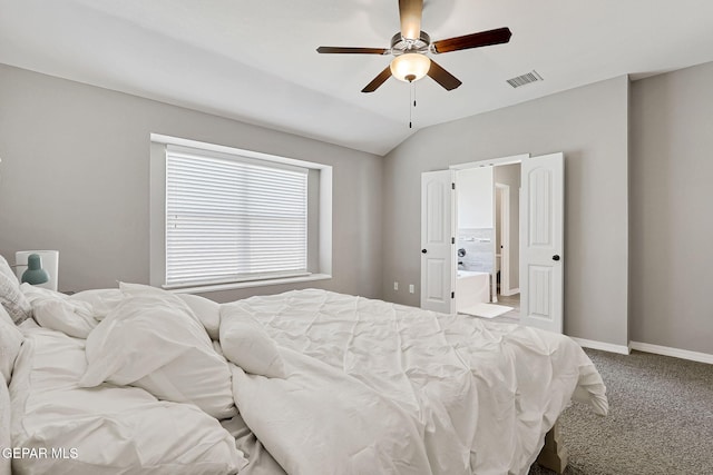 bedroom with visible vents, ensuite bath, carpet, baseboards, and vaulted ceiling