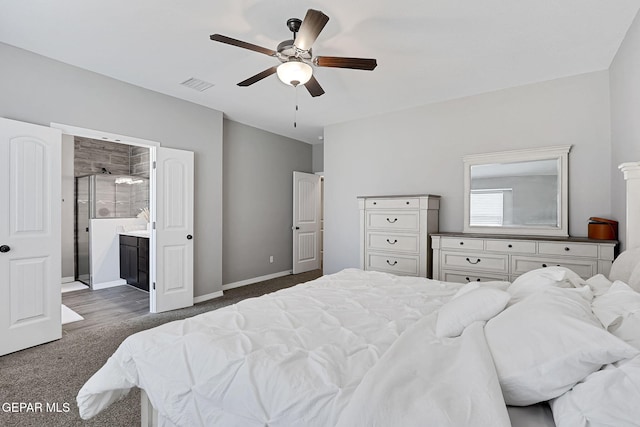 carpeted bedroom with visible vents, ceiling fan, ensuite bathroom, and baseboards