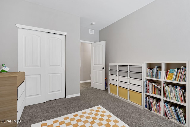 carpeted bedroom featuring a closet, visible vents, and baseboards